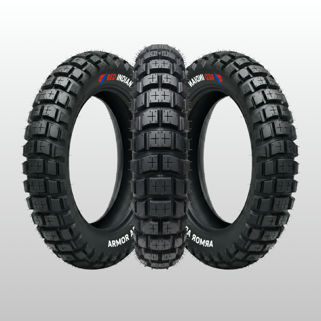 Three off-road tires with visible branding on a gray background