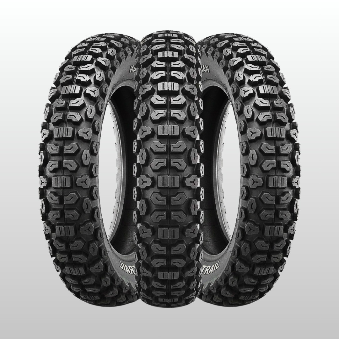 Three off-road tires with tread patterns on a light gray background