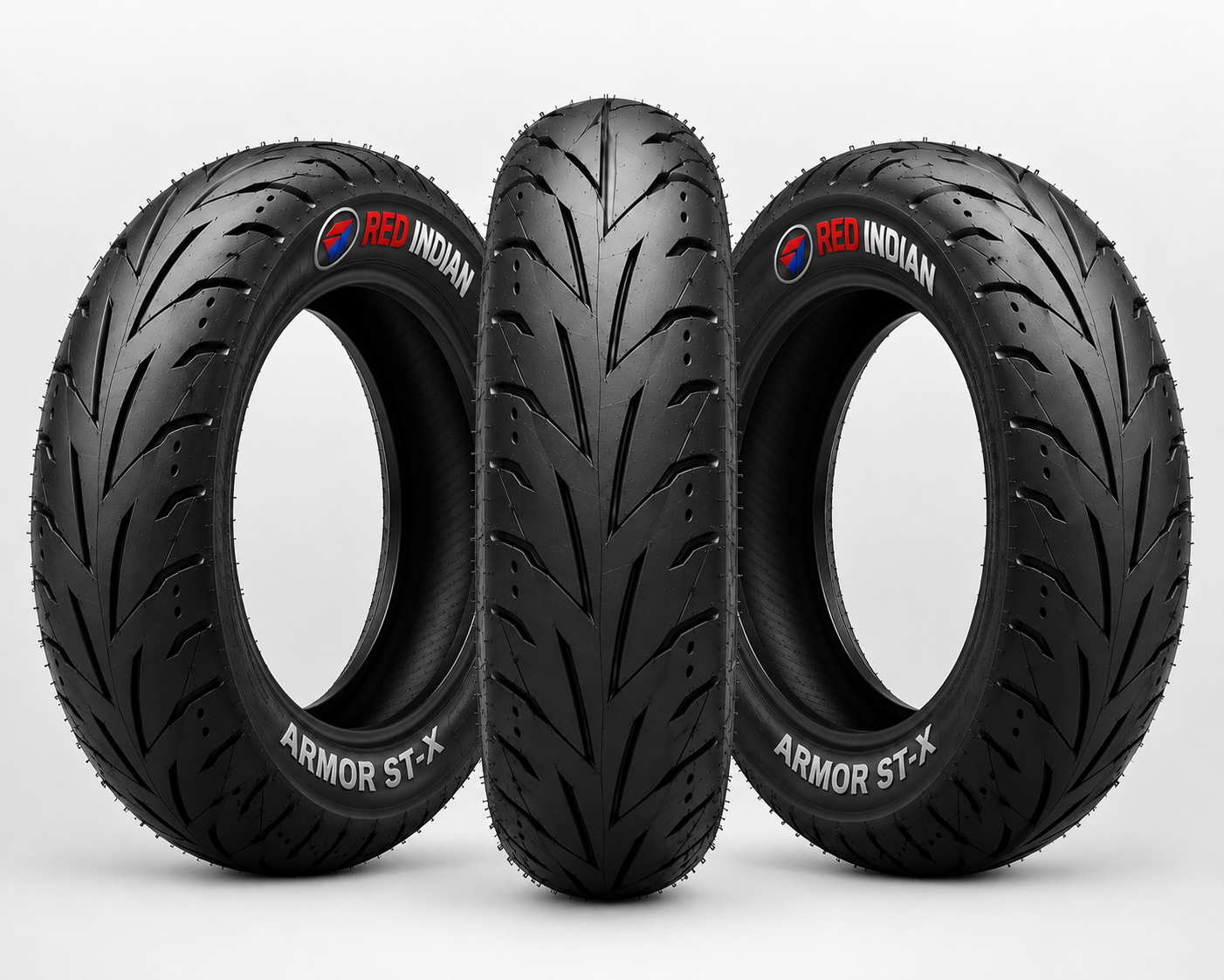 Three black motorcycle or scooter tires arranged upright against a light gray studio background. The tires show the Red Indian brand name and the model name Armor ST-X.