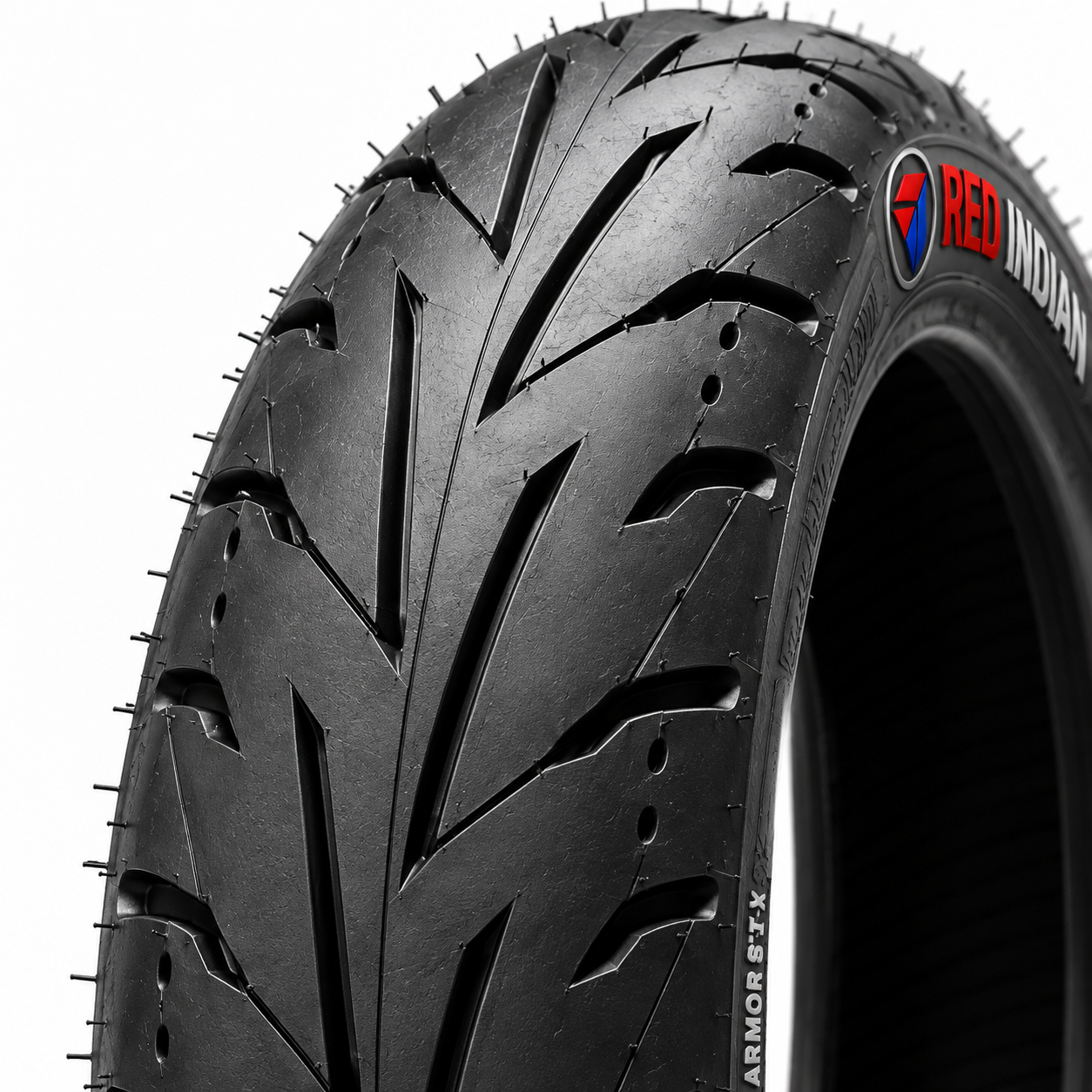 A close-up studio shot of a black motorcycle tire showing its tread pattern and sidewall branding, including the Red Indian logo and 'ARMOR 67X' text, against a plain white background.