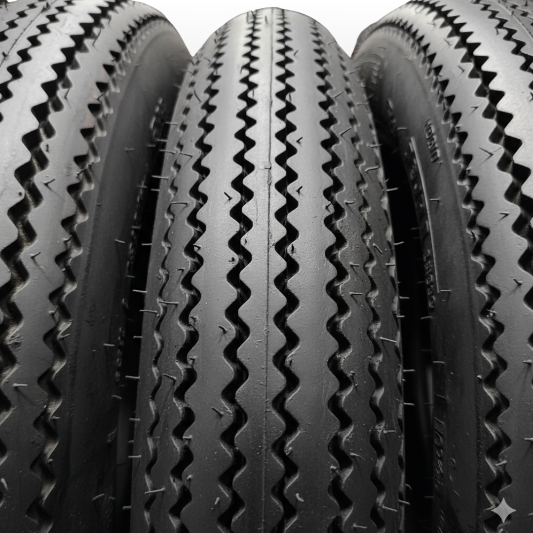 Close-up of three tires with tread patterns on a white background