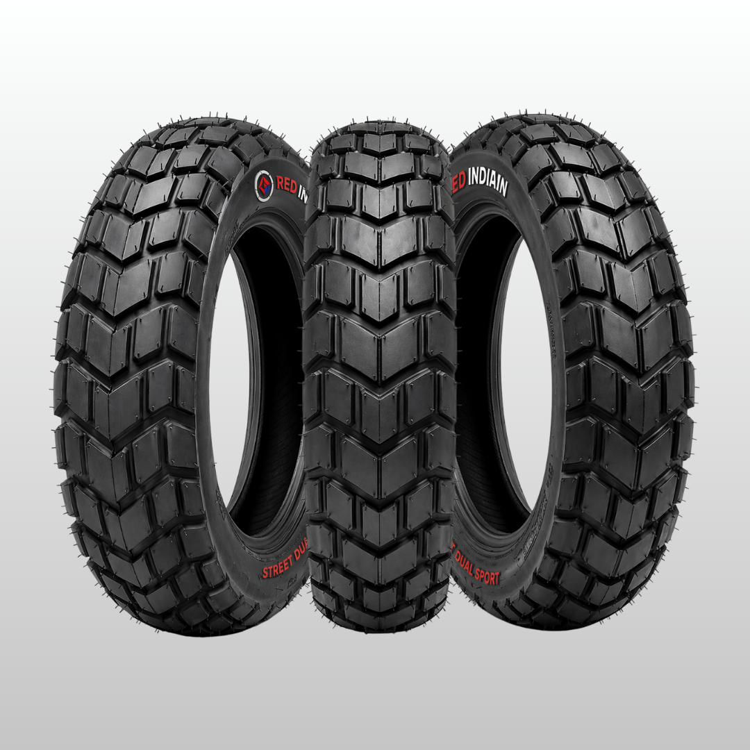 Three motorcycle tires with tread patterns on a gray background