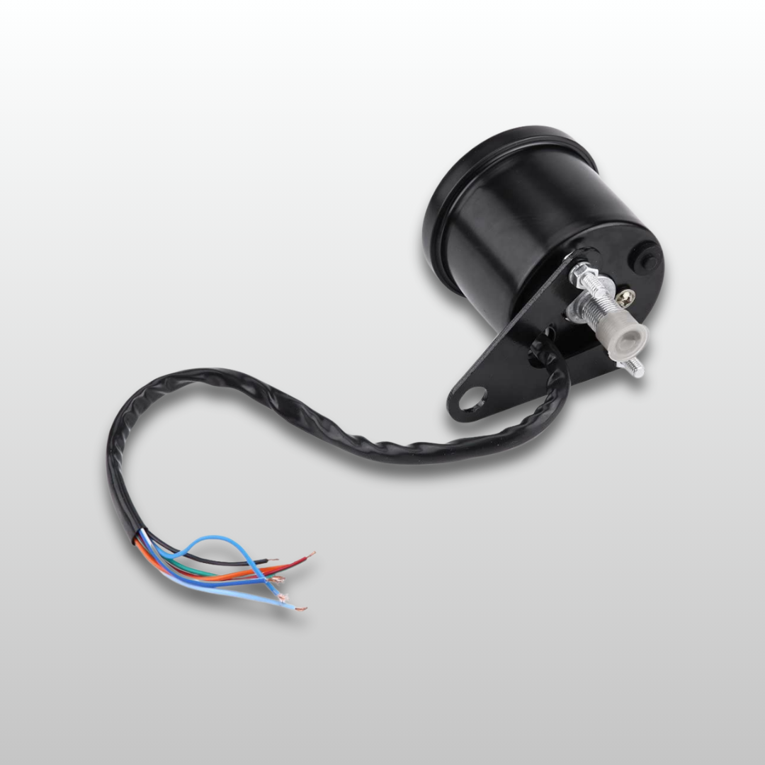 Black back-view of the speedometer electronic component with wires on a light gray background