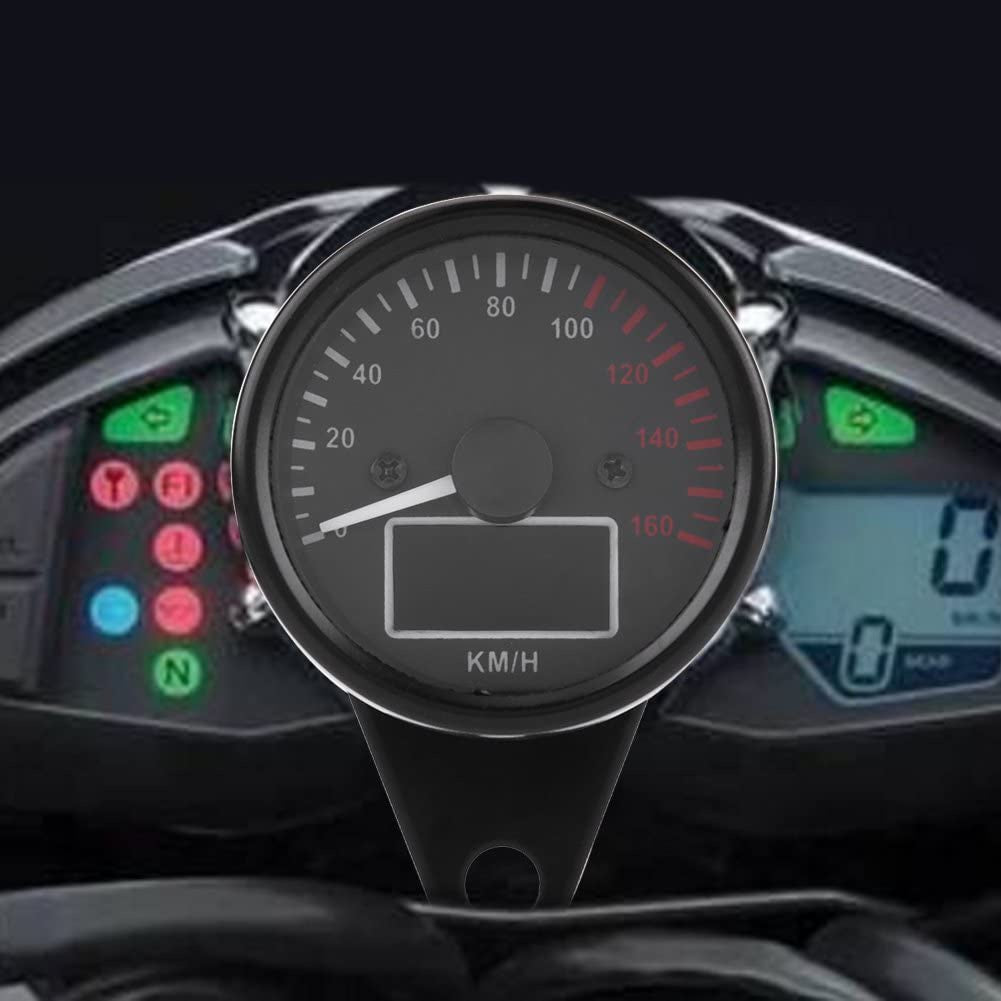 Close-up of a motorcycle dashboard with speedometer and digital displays.